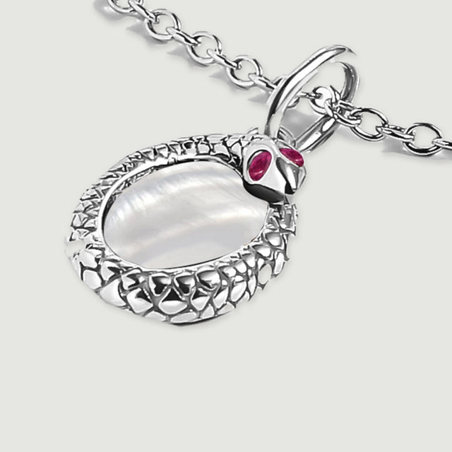 An angled view of the white rhodium plated pendant shows the raised edge, oval shell center, and connecting bail.