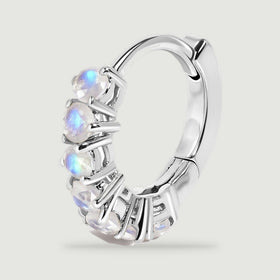 A single silver-tone hoop reveals its curved back, hinge, and row of moonstones.