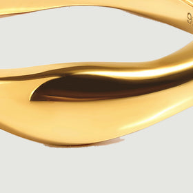 A close view of the yellow gold vermeil ring shows the smooth tapered face and curved reflective ridge.