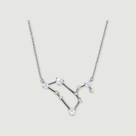 A silver necklace shows round iridescent moonstones and clear accents connected by polished angular bars.