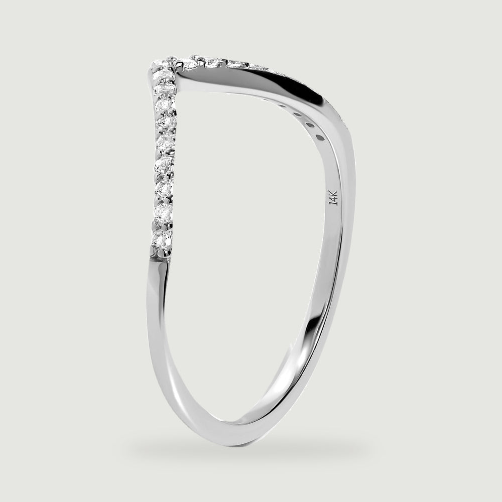 An upright white gold ring reveals its polished side, small stone settings, and inner 14K stamp.