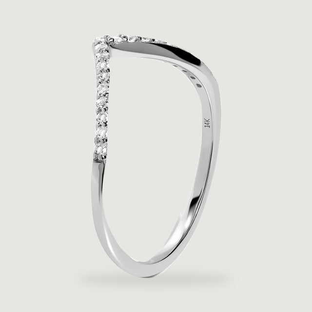 An upright white gold ring reveals its polished side, small stone settings, and inner 14K stamp.