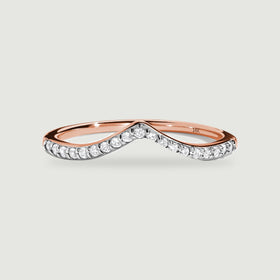 A rose gold ring displays round diamonds along its curved pointed front.