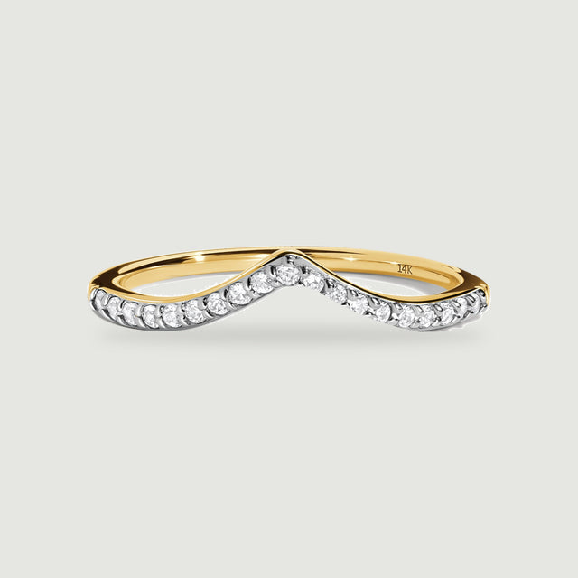 A yellow gold ring with a raised central point and bright round stones is shown from the front.