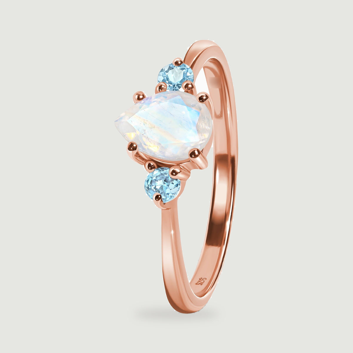 The ring stands at an angle, showing its raised stone setting and curved rose gold band.