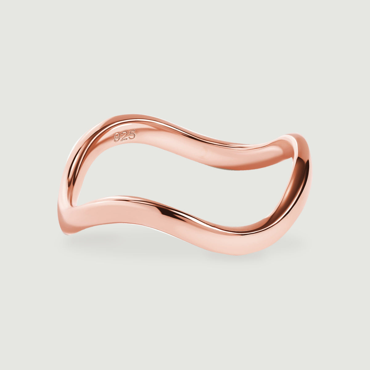 A rose gold ring displays its curved outline and open center on a pale gray background.