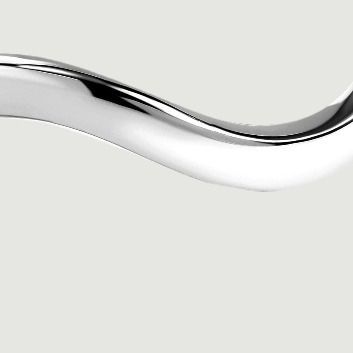 A close view shows the silver band curving across the foreground with bright polished reflections.