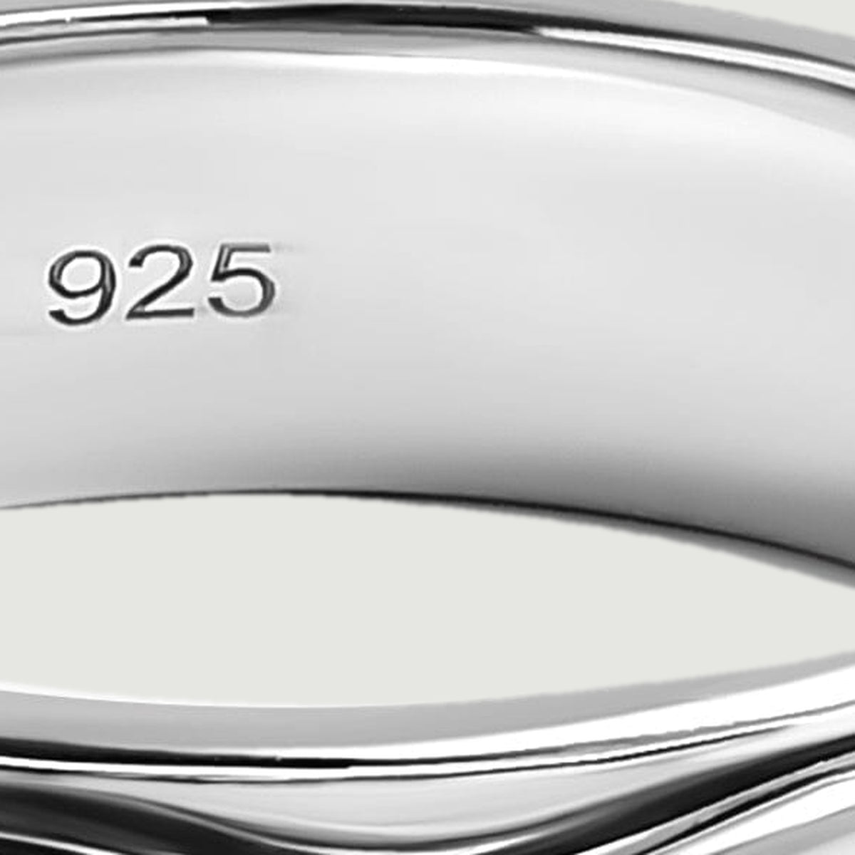 The 925 stamp is visible on the smooth inner wall of the silver ring.