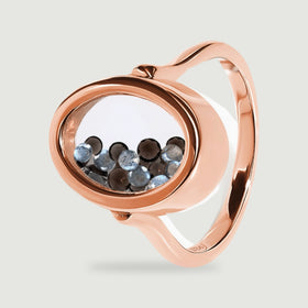 A side view of the rose gold vermeil ring shows polished metal around an oval window filled with small dark and blue gray gems.