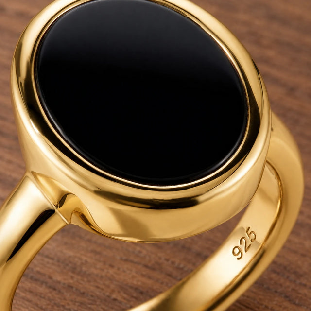 Stillpoint black onyx oval ring in yellow gold vermeil, close-up of the bezel and band hallmark.