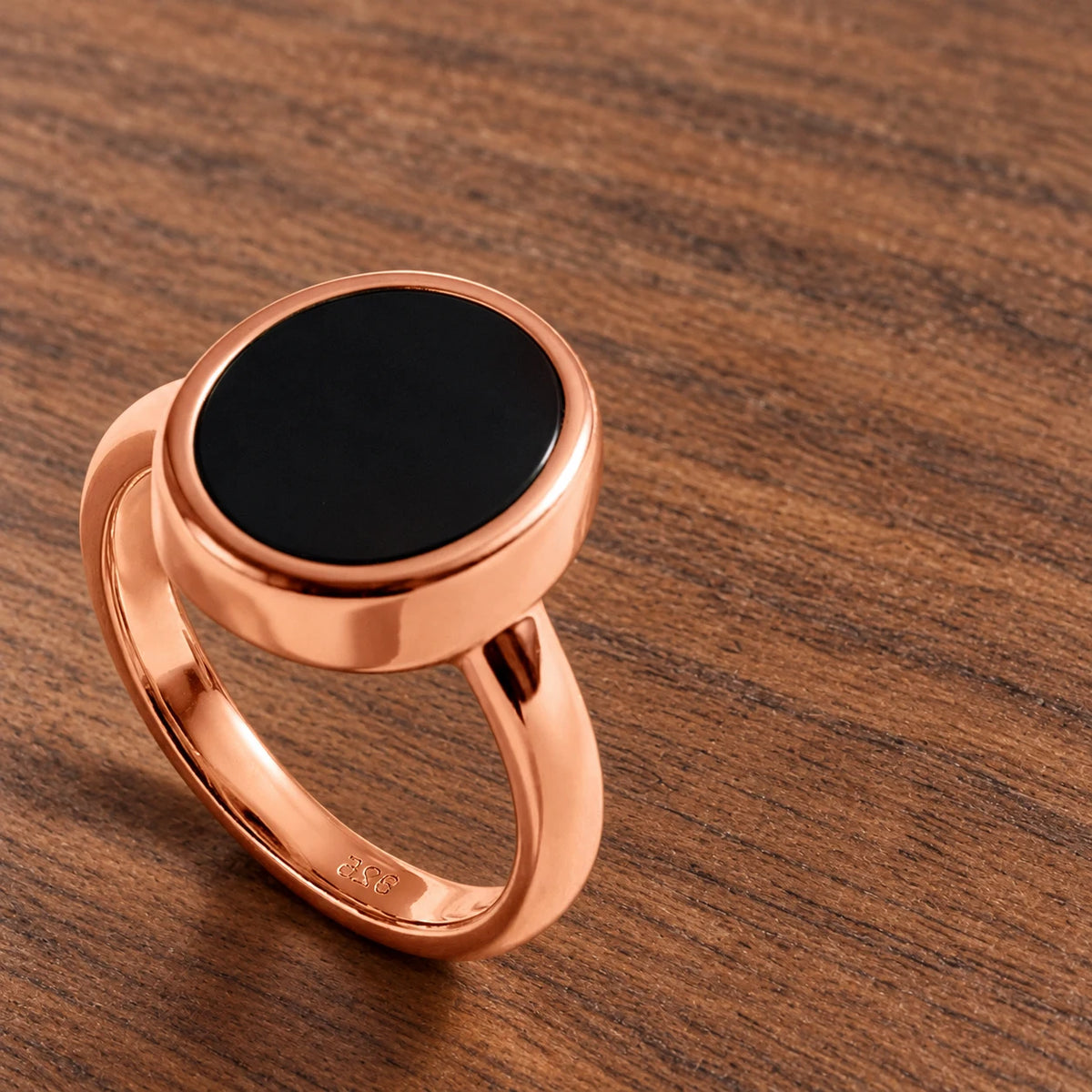 Stillpoint black onyx oval ring in rose gold vermeil, side view of the bezel and closed band.