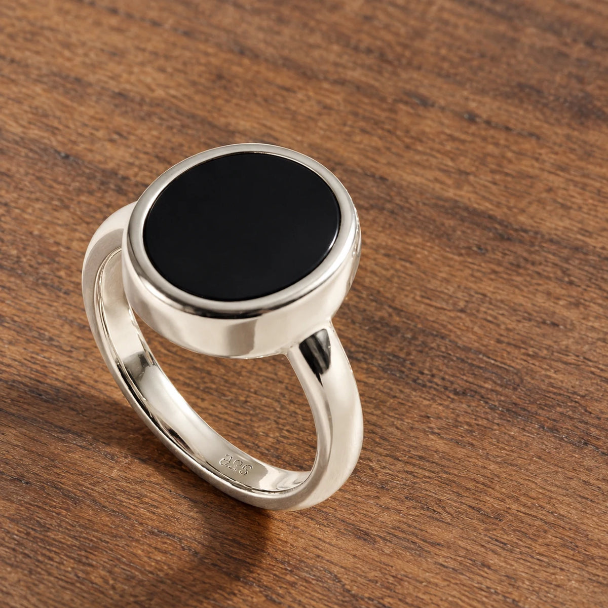 Stillpoint black onyx oval ring in sterling silver, side view of the bezel and closed band.