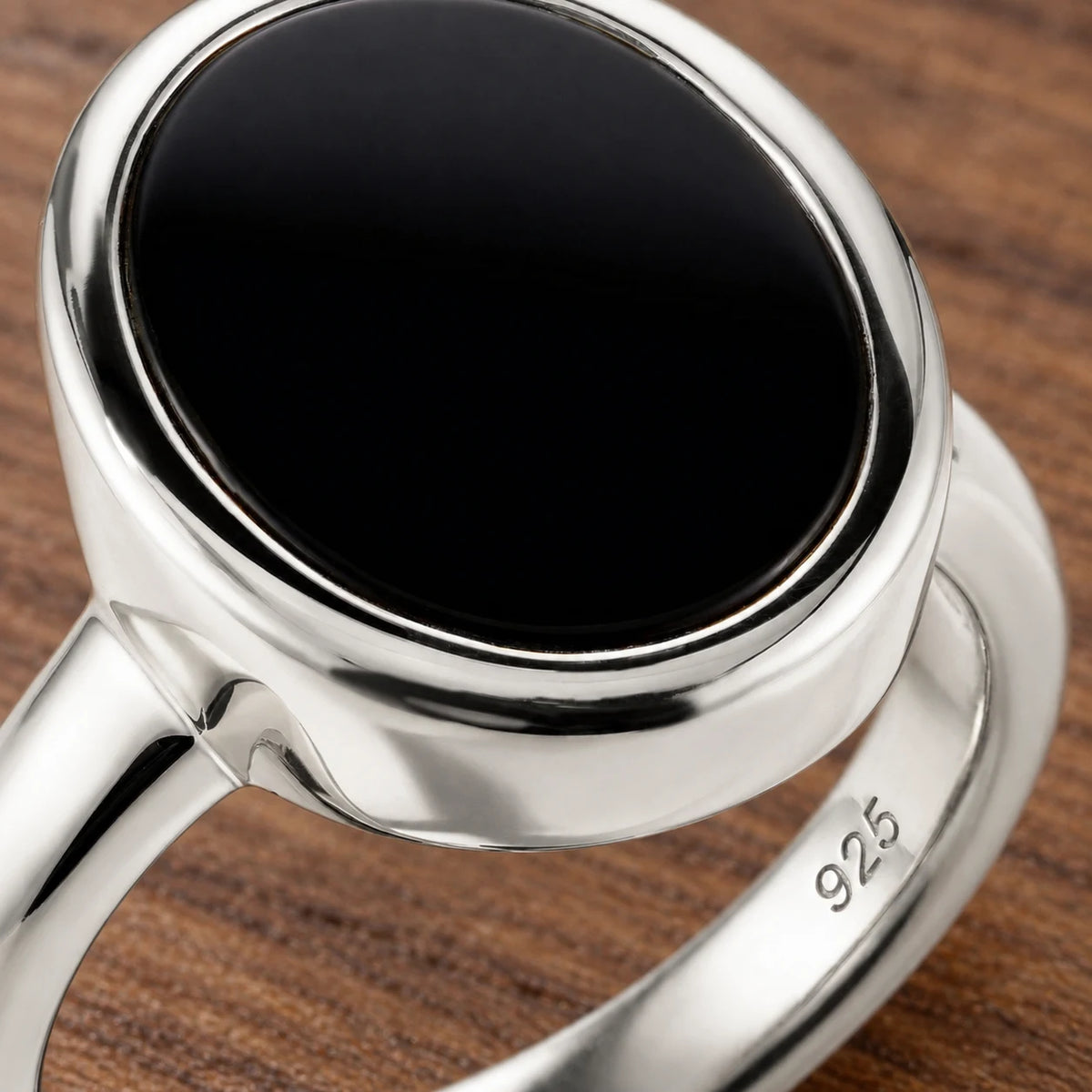 Stillpoint black onyx oval ring in sterling silver, close-up of the bezel and band hallmark.
