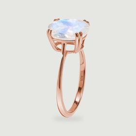 The rose gold ring stands in profile, revealing the raised setting and polished inner band.