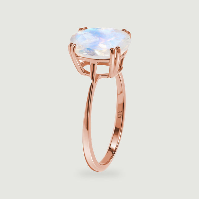 The rose gold ring stands in profile, revealing the raised setting and polished inner band.