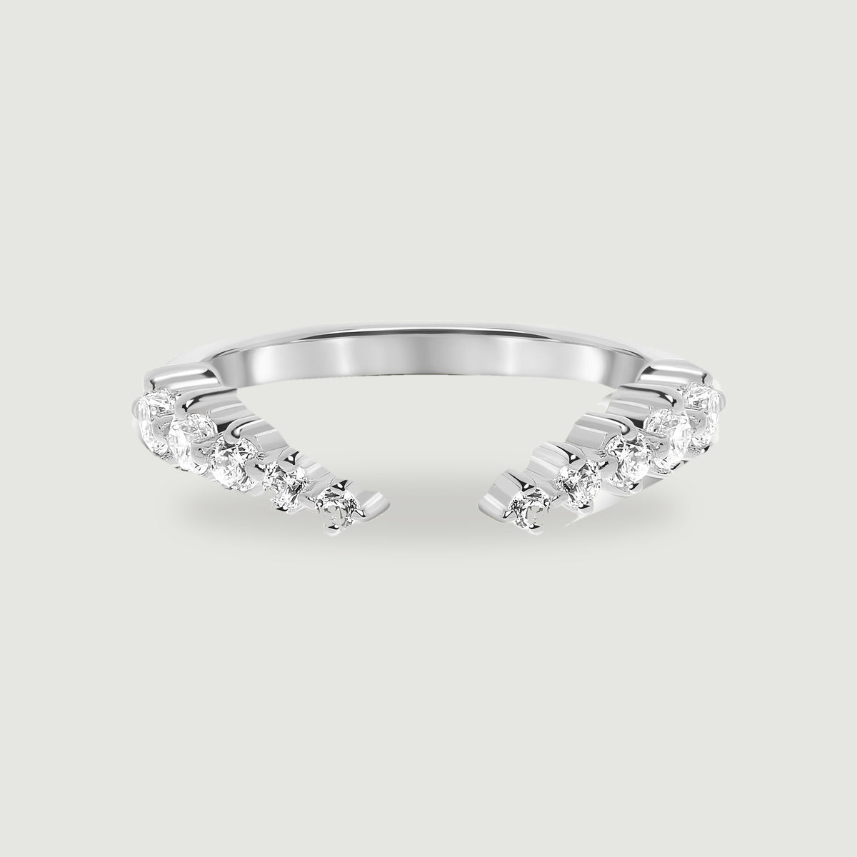 A polished sterling silver open ring displays two curved rows of round clear stones on a light gray background.