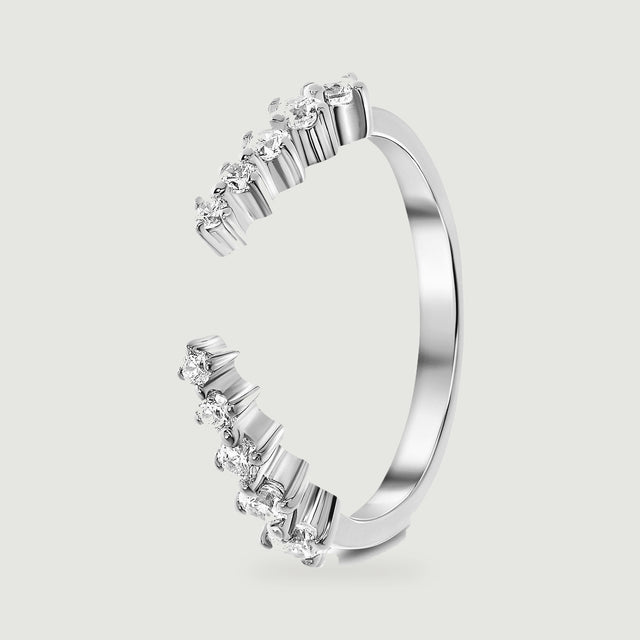 An upright silver ring shows the smooth rear band and raised settings around its open front.