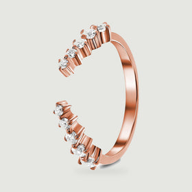A rose gold vermeil band stands at an angle, revealing its rounded shank and individual stone settings.