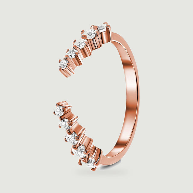 A rose gold vermeil band stands at an angle, revealing its rounded shank and individual stone settings.