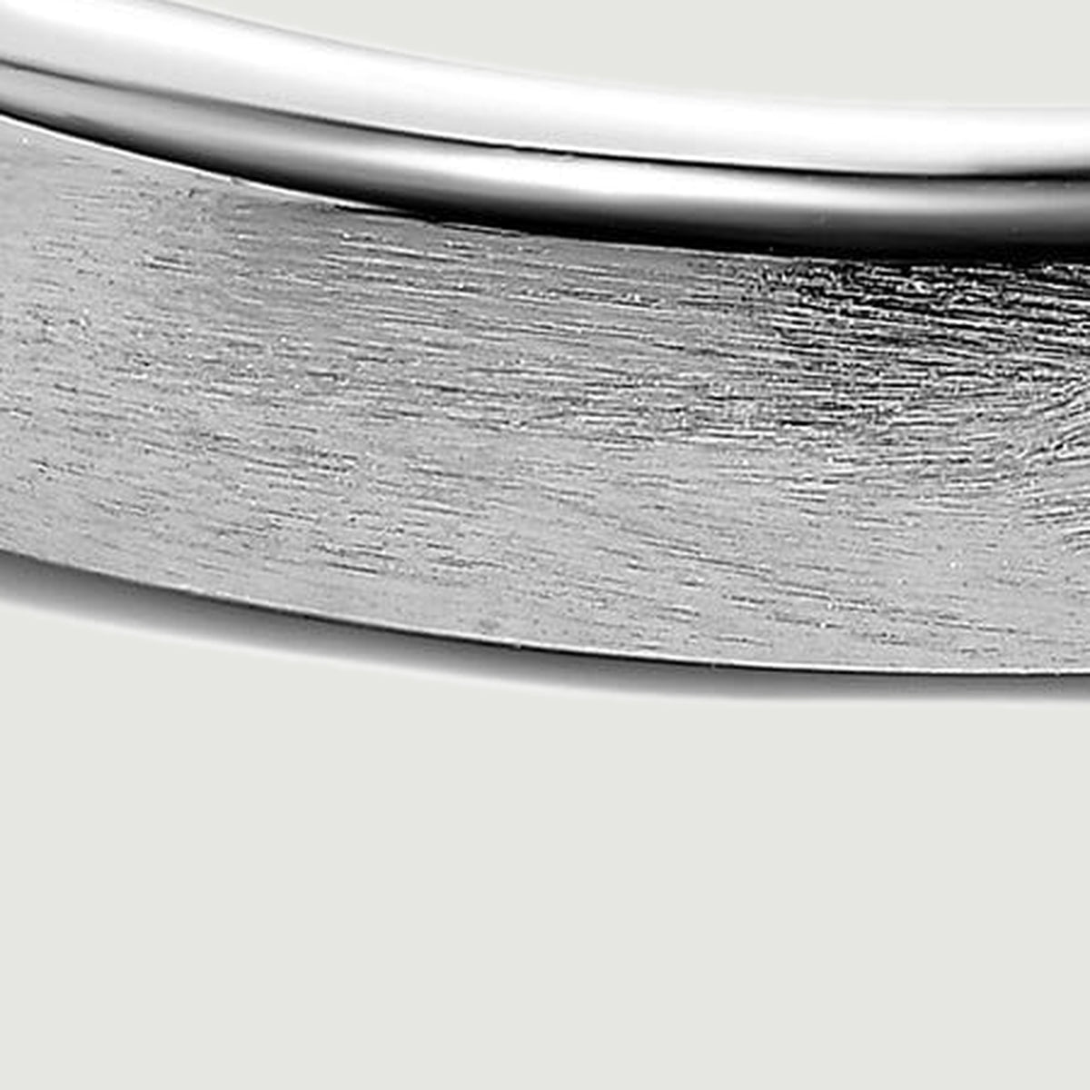 Fine brushed lines cover the silver band below its smooth reflective edge.