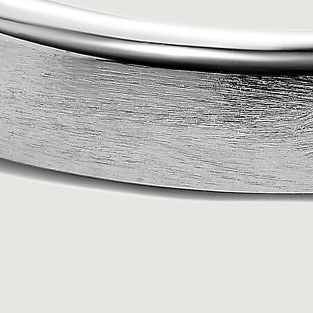 Fine brushed lines cover the silver band below its smooth reflective edge.