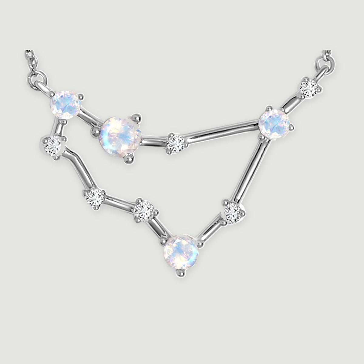 The silver necklace centerpiece displays reflective round stones, fine prongs, and slender connecting bars.