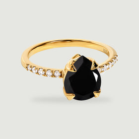 A yellow gold vermeil ring displays a black pear-shaped stone above a band lined with small clear stones.