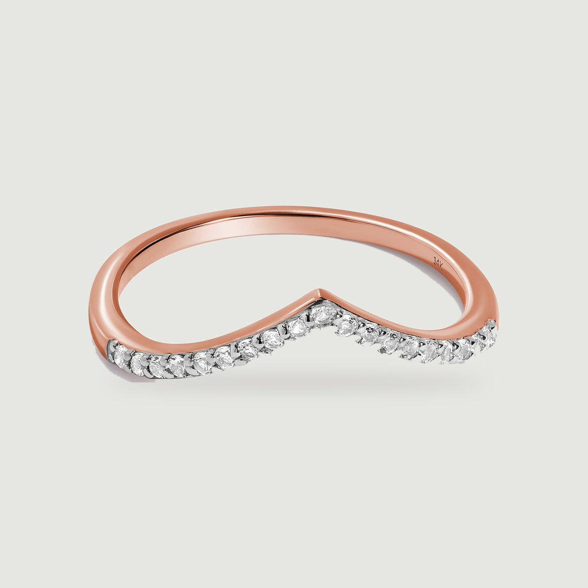 A rose gold chevron band with a row of round diamonds is shown at a three-quarter angle.