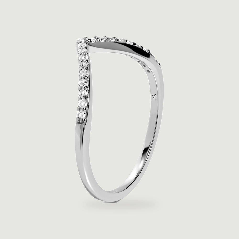 An upright white gold ring reveals the slim band, raised diamond settings, and inner 14k hallmark.