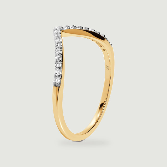 The yellow gold ring is shown from the side with its polished shank and diamond prongs visible.