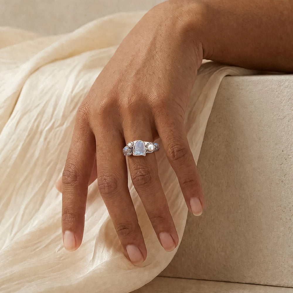 Tidal Bloom moonstone pearl cluster ring, sterling silver, shown on hand with linen