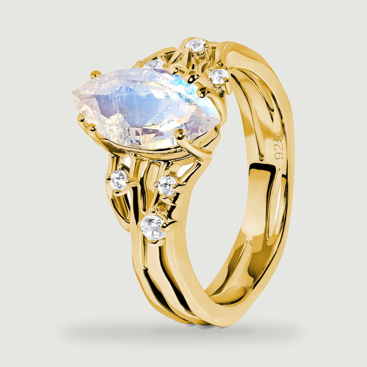 An angled yellow gold vermeil ring reveals the raised moonstone setting and curved open shoulders.