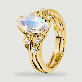 An angled yellow gold vermeil ring reveals the raised moonstone setting and curved open shoulders.
