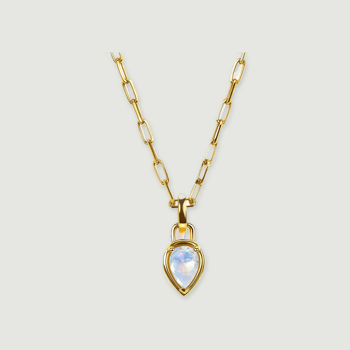 A yellow-gold-tone chain leads to a pointed moonstone pendant against a light gray background.