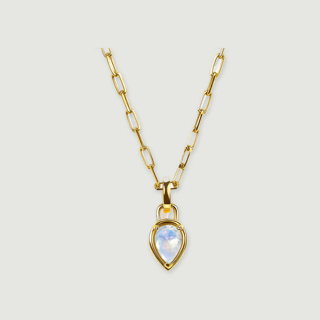 A yellow-gold-tone chain leads to a pointed moonstone pendant against a light gray background.