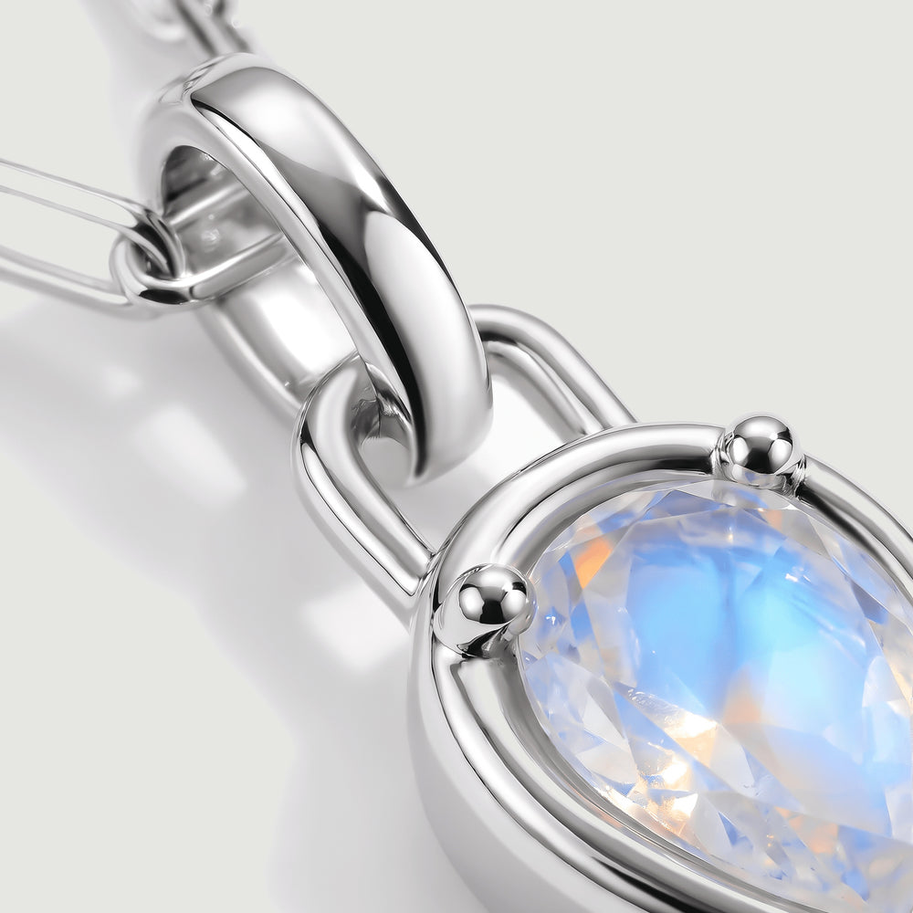 A close-up shows the polished silver-tone bail, rounded prongs, and blue reflections inside the moonstone.