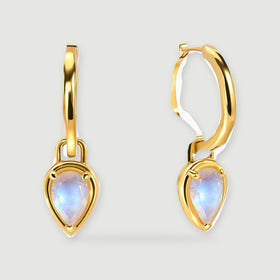 A pair of yellow-gold-tone hoops is shown with faceted pear-shaped moonstones and soft shadows.