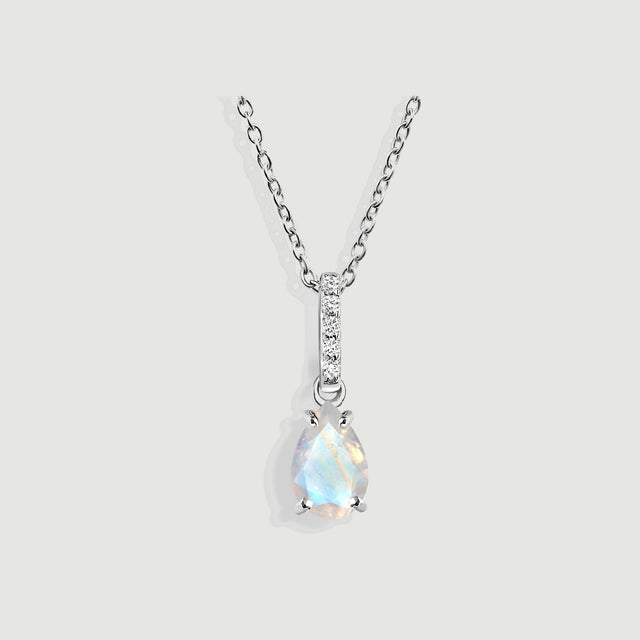 A pear-shaped moonstone hangs below a five-diamond bail on a sterling silver chain against a light gray background.