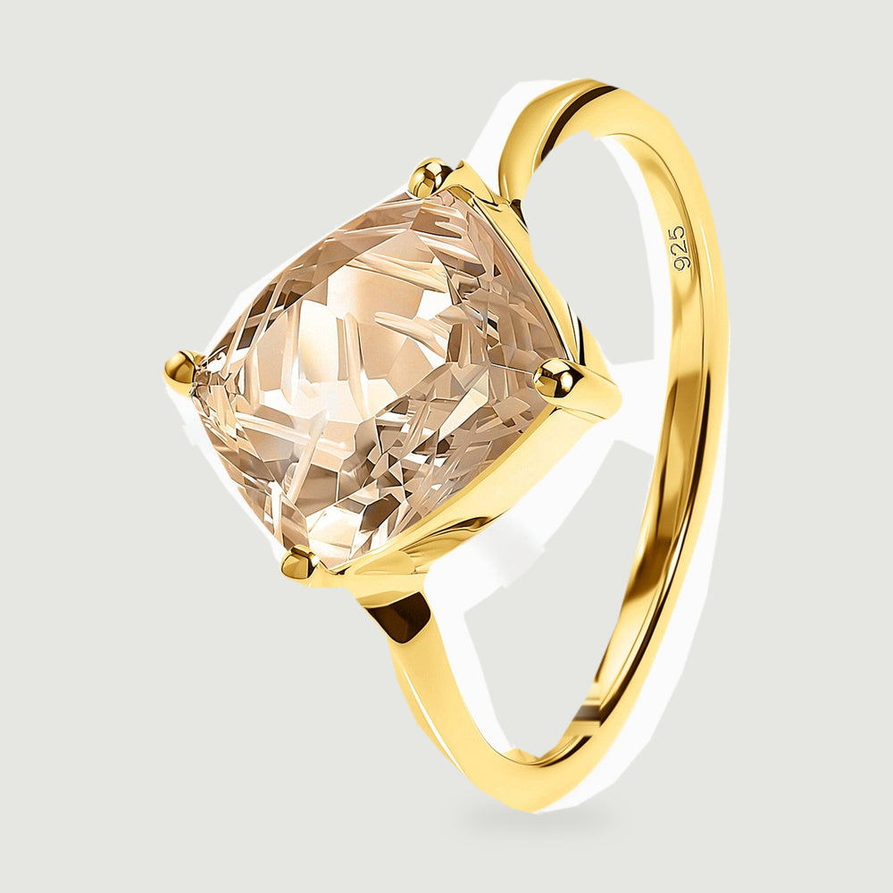 An angled view shows the yellow gold band, raised prongs, and carved champagne quartz.