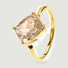 An angled view shows the yellow gold band, raised prongs, and carved champagne quartz.