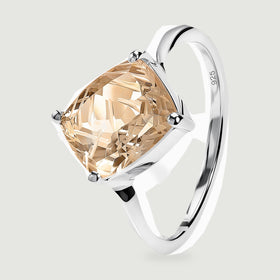 The silver ring stands at an angle, showing its curved band and the height of the quartz setting.