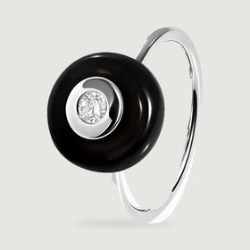 An upright silver ring shows the raised black stone and the slender band from an angled side view.