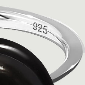 The inner silver band bears a visible 925 stamp beside its polished curved edge.