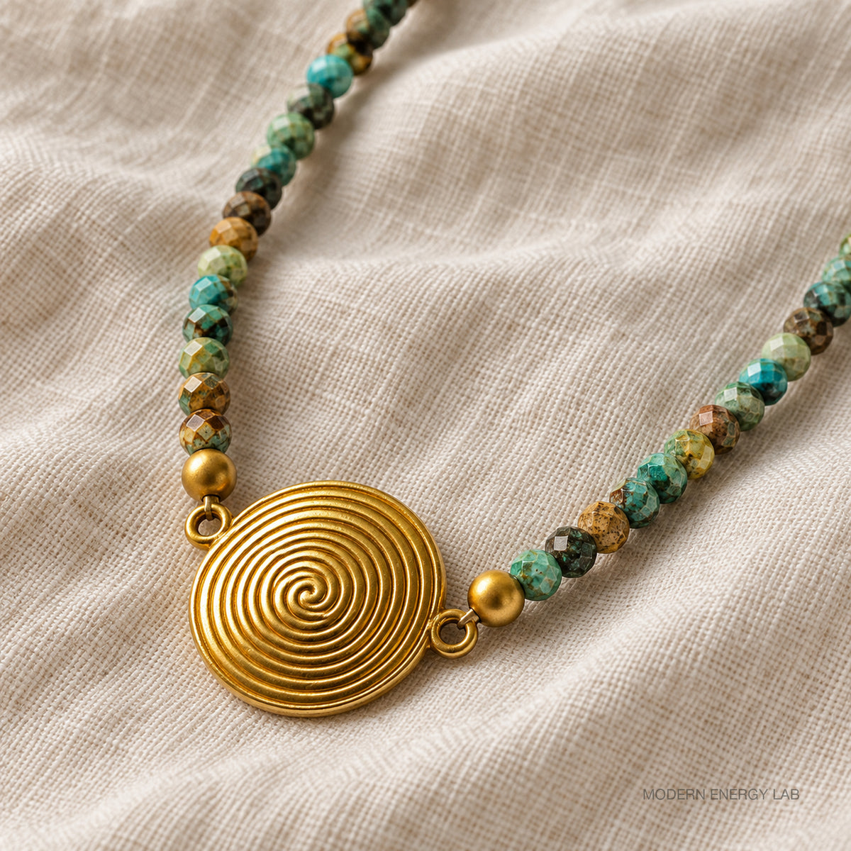 New angled close view of the spiral pendant and faceted turquoise beads on ivory linen