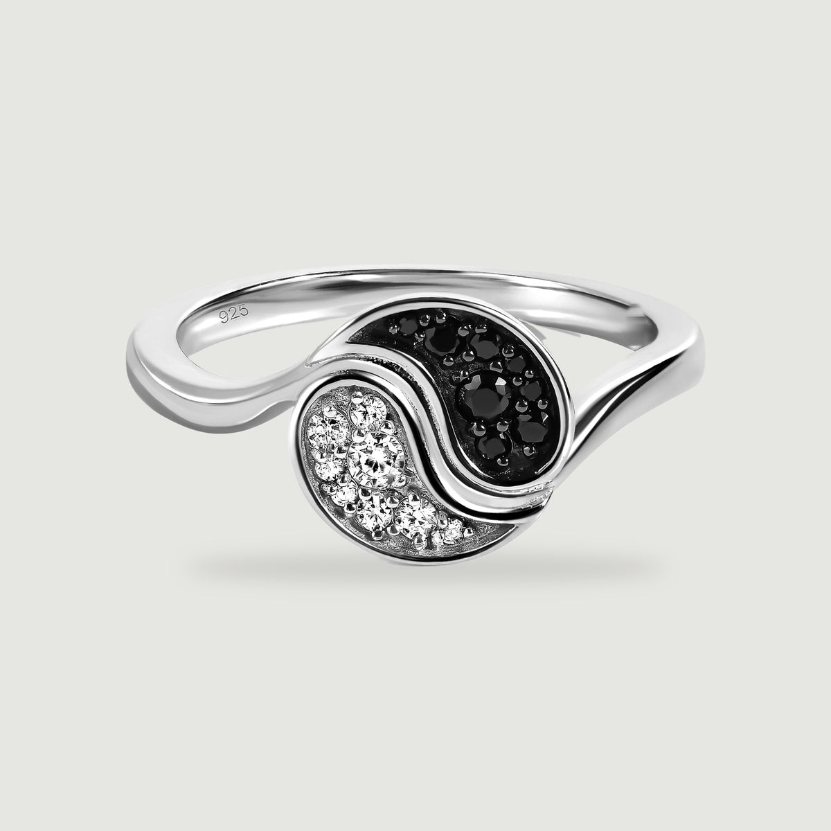 A silver ring displays black and clear stone clusters within a flowing circular setting.