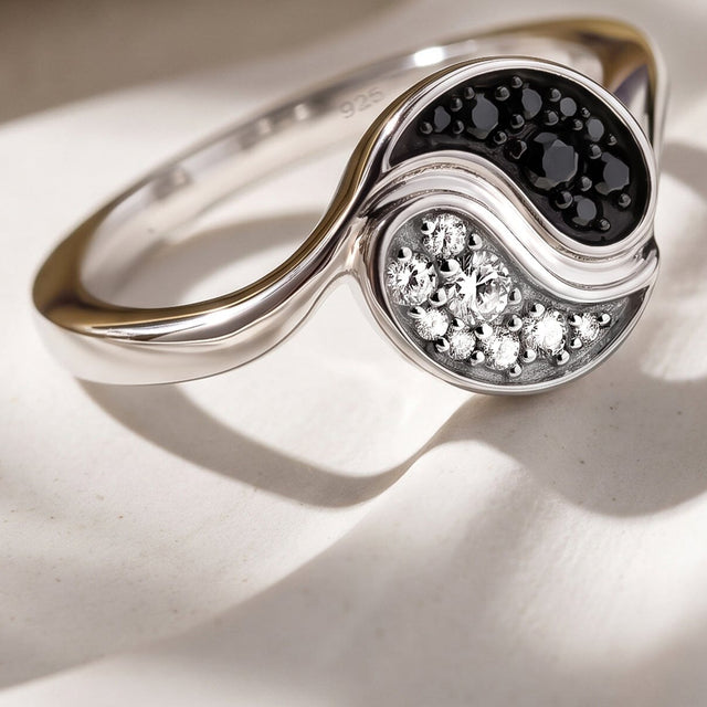 An angled close view of a silver ring shows the slender band joining its raised stone setting.