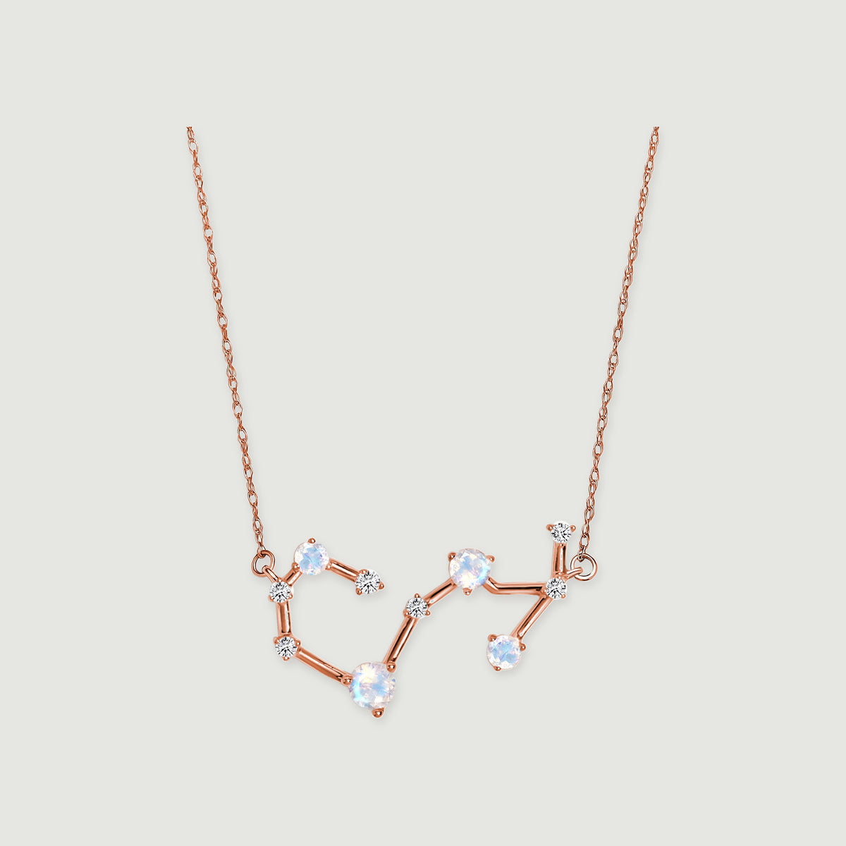 A rose gold necklace with linked round moonstones and small diamonds is centered on a light gray background.