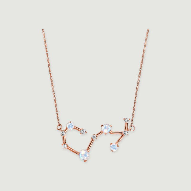 A rose gold necklace with linked round moonstones and small diamonds is centered on a light gray background.
