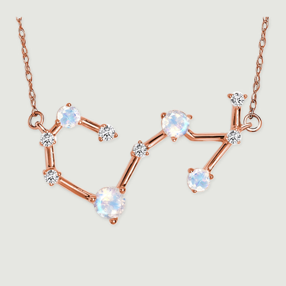 The complete angular pendant and its connecting chain links lie against a pale gray surface.