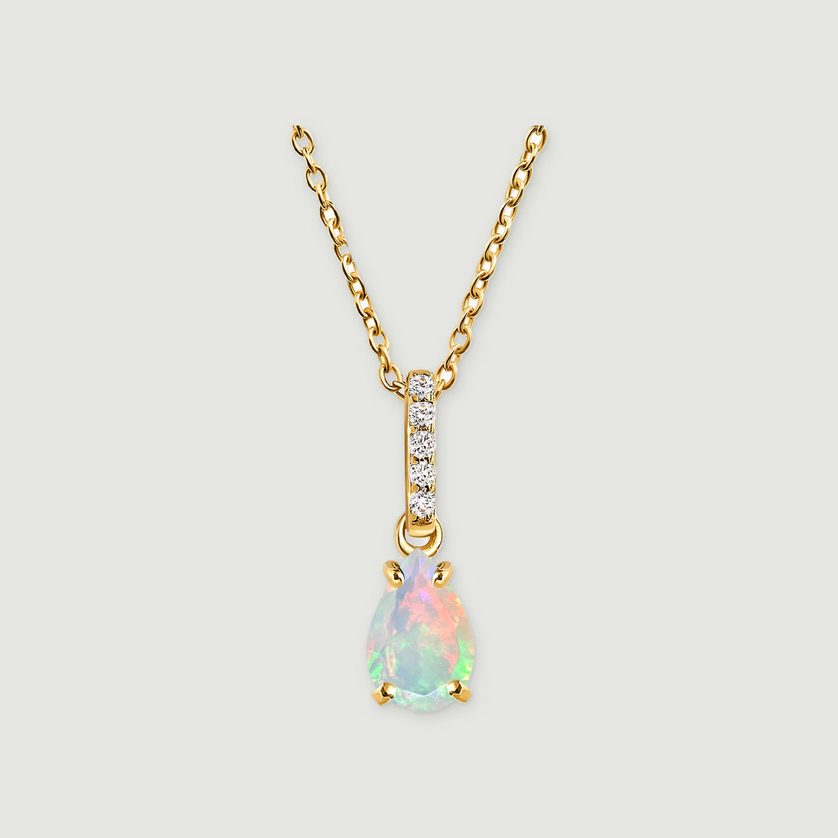A yellow gold necklace has a pear-shaped opal below a vertical row of five clear stones on a light gray background.